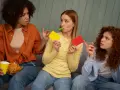 Tre vänner spelar par med en lek, en med gul och röd kort, en med chips och en med visselpipa.