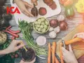 ICA-logotypen över en bild av färska grönsaker som förbereds för ett recept. Rödbetor skivas, morötter skalas och en skål med puré.