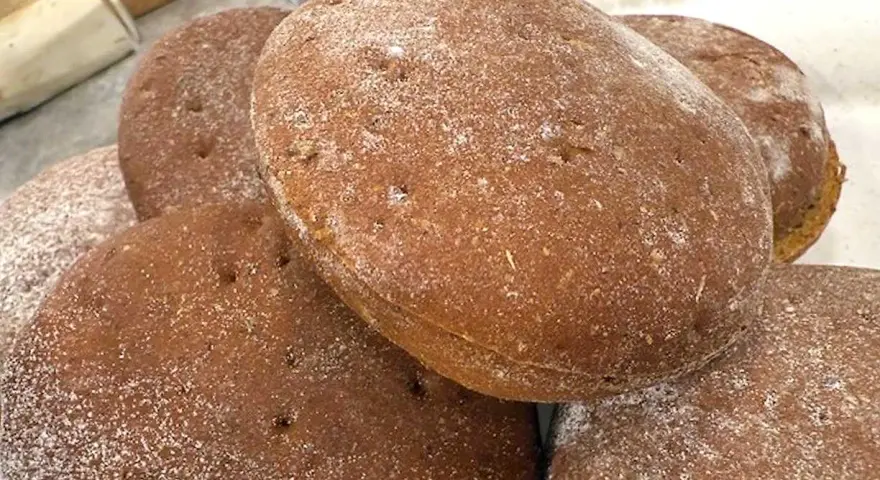 Färska rågkakor, perfekta för ett enkelt rågkakor recept. Pudrade med mjöl, redo att avnjutas.