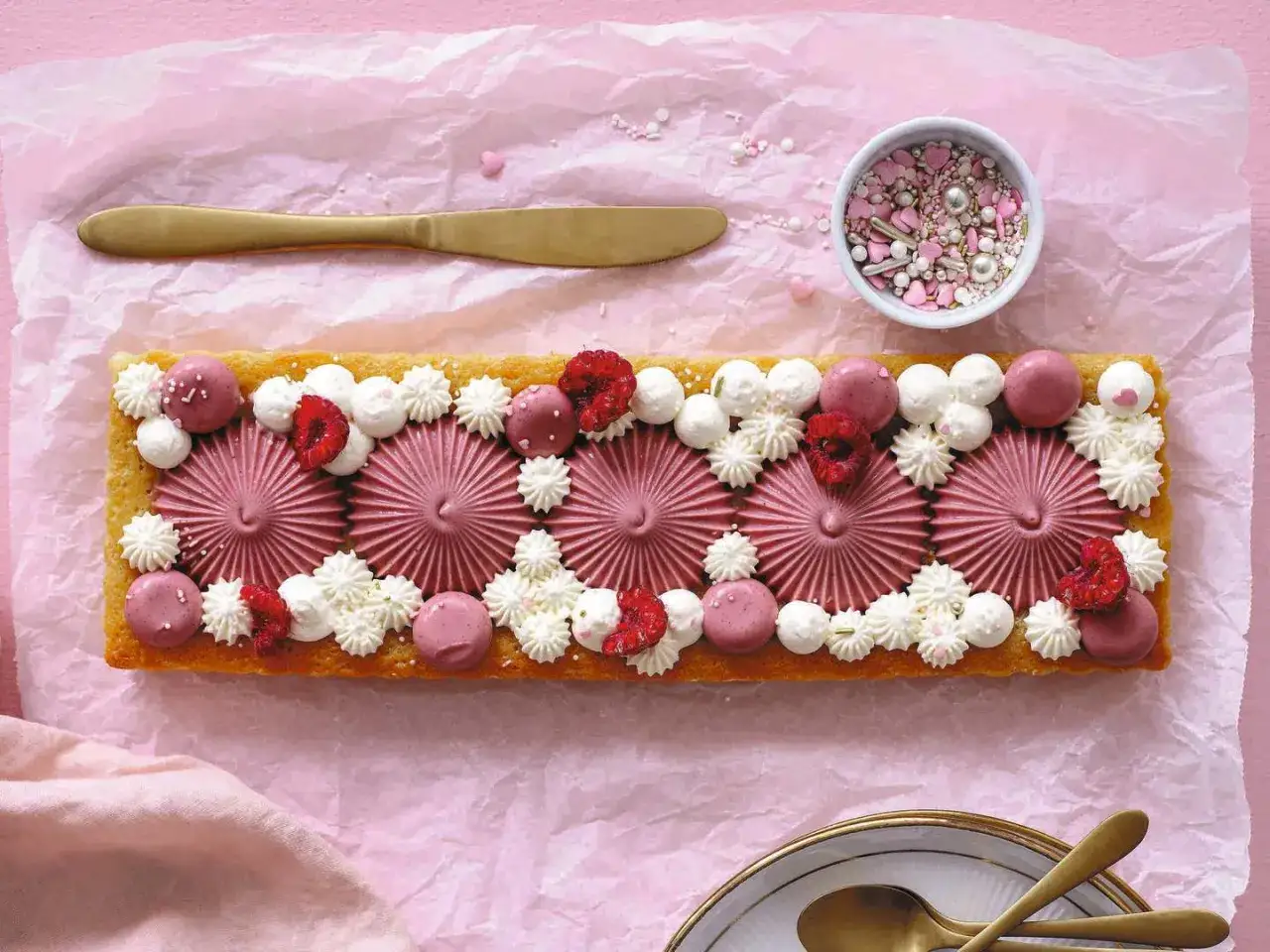 En vacker, rektangulär snabb kladdkaka dekorerad med rosa frosting, hallon och grädde. Perfekt för ett festligt fika!
