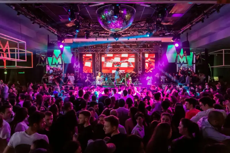 Folk dansar och festar på en 30-årsfest. En discokula hänger i taket och scenen lyses upp av färgglada lampor.